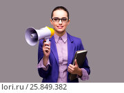 Young businesswoman with loudspeaker on gray background. Стоковое фото, фотограф Elnur / Фотобанк Лори