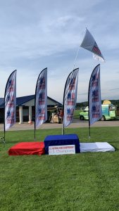 U.S National Kubb Championship champions, second, and third place podiums with USA Kubb flags flying in the background (Eau Claire, Wisconsin)