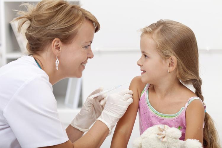 School nurse administering an injection to a child.