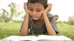 Teenage student reading a book