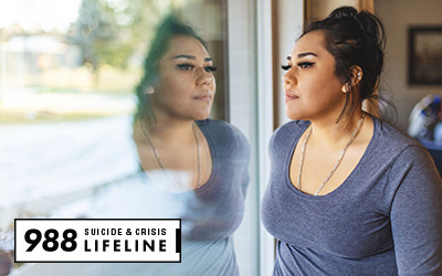 Latina woman looking out a window