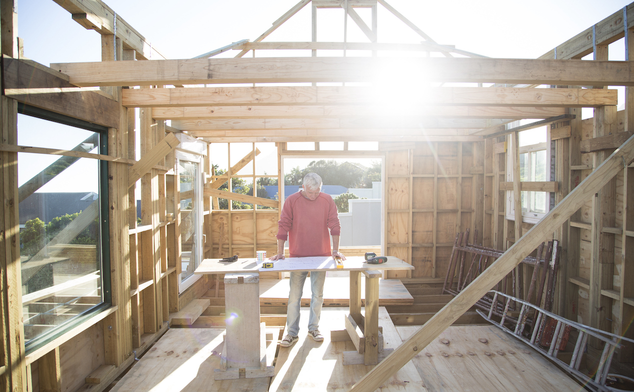 Builder working on framing a house