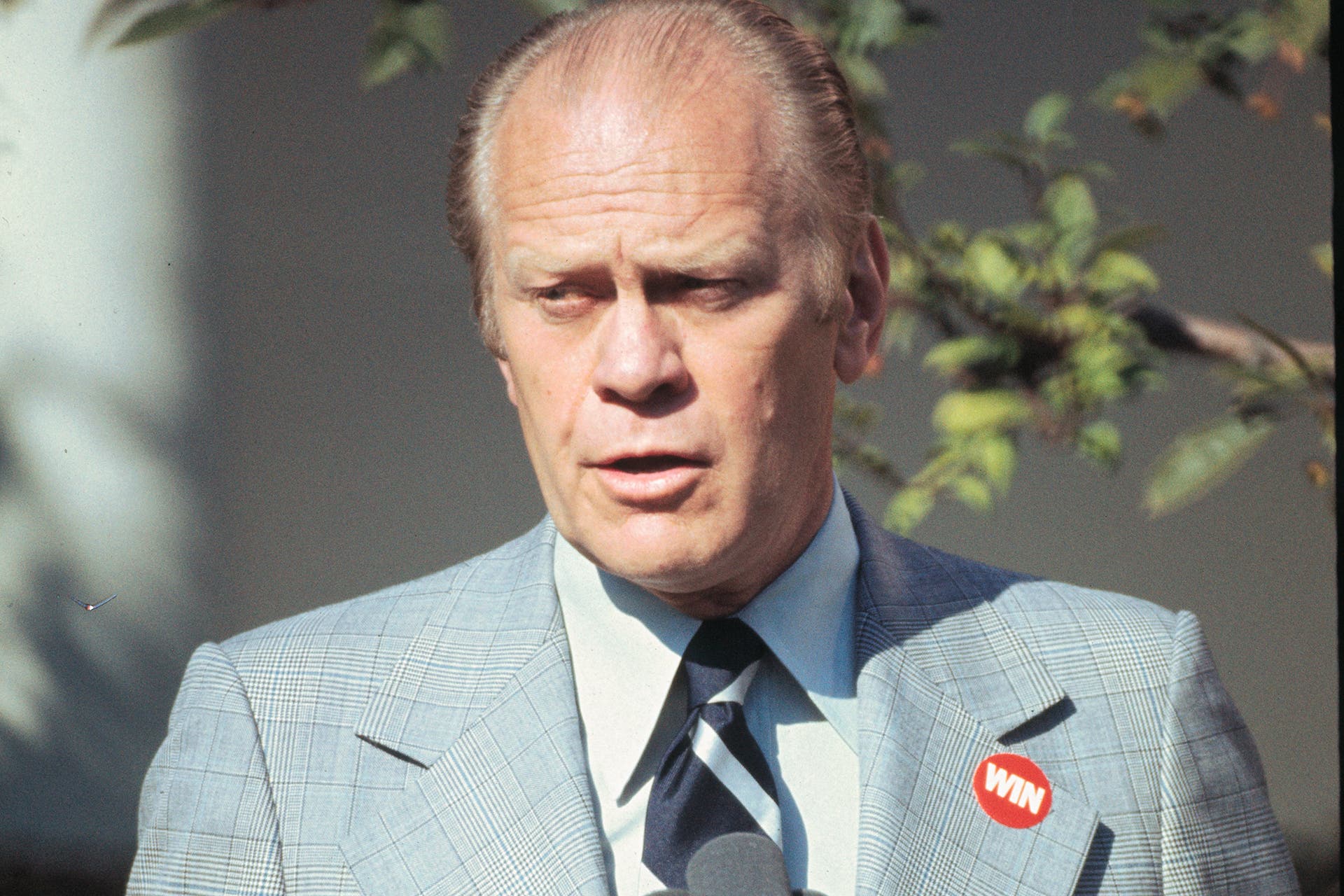 President Gerald Ford wearing a WIN (Whip Inflation Now) button on his lapel during Republican campaigns in North & South Carolina.