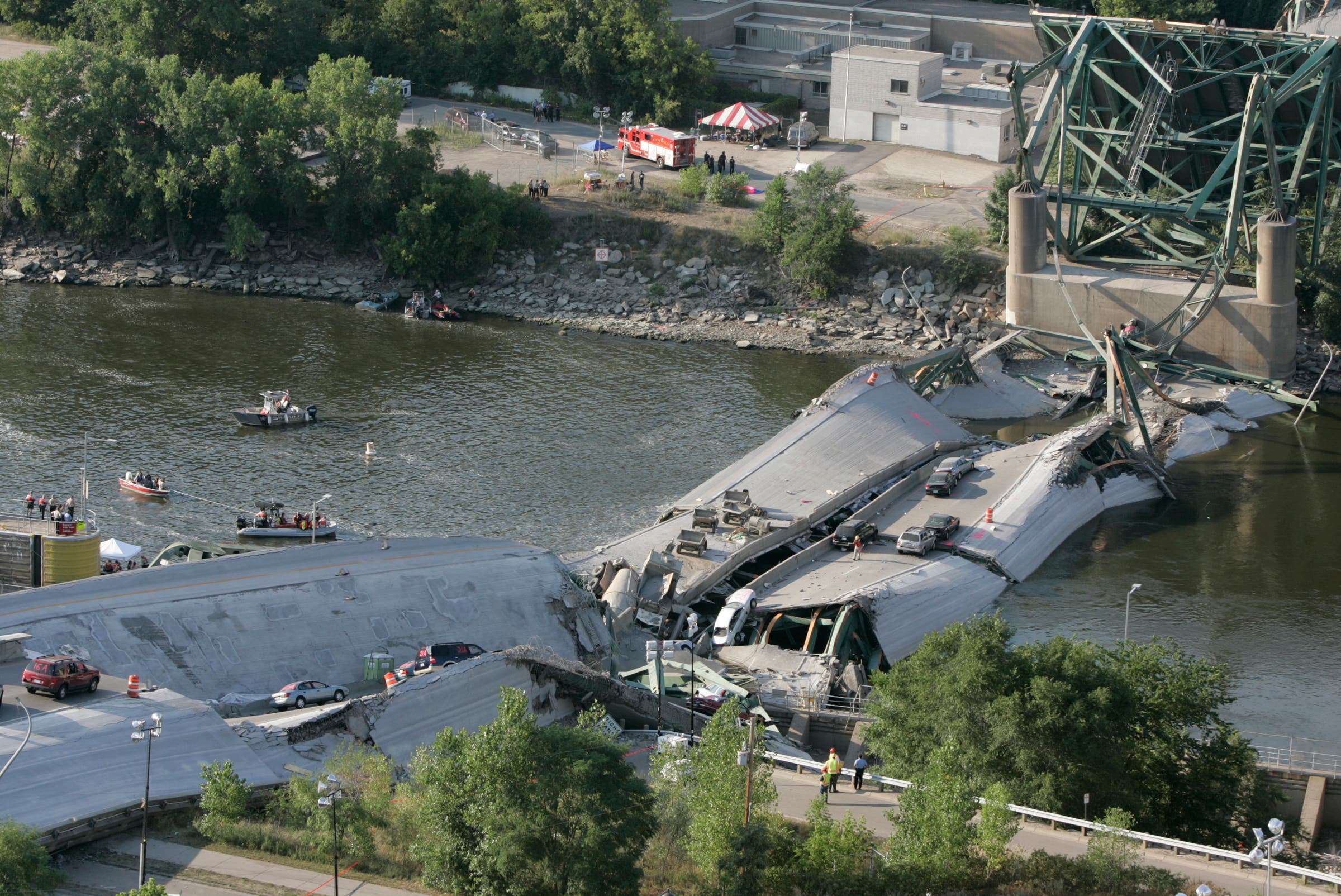 August 3, 2007. Minneapolis, Minnesota. Investigators move cautiously amid the rubble of the 35W bridge that lies in pieces in the Mississippi River.