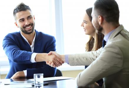 Lawyer and client shaking hands, finishing up a meeting.