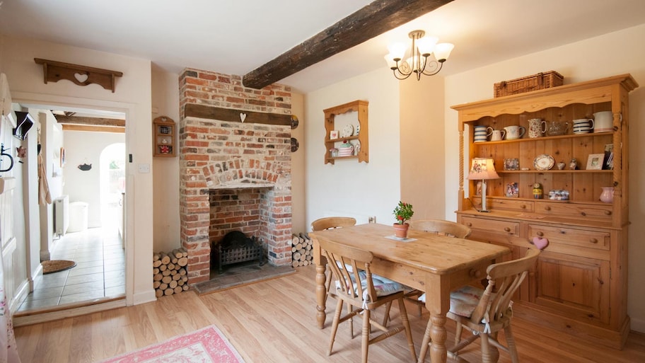 A kitchen with exposed brick fireplace