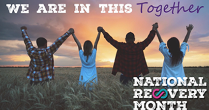 Four people holding hands and jumping in a field at sunset with text reading, “We are in this together. National Recovery Month: Hope is real. Recovery is real.”