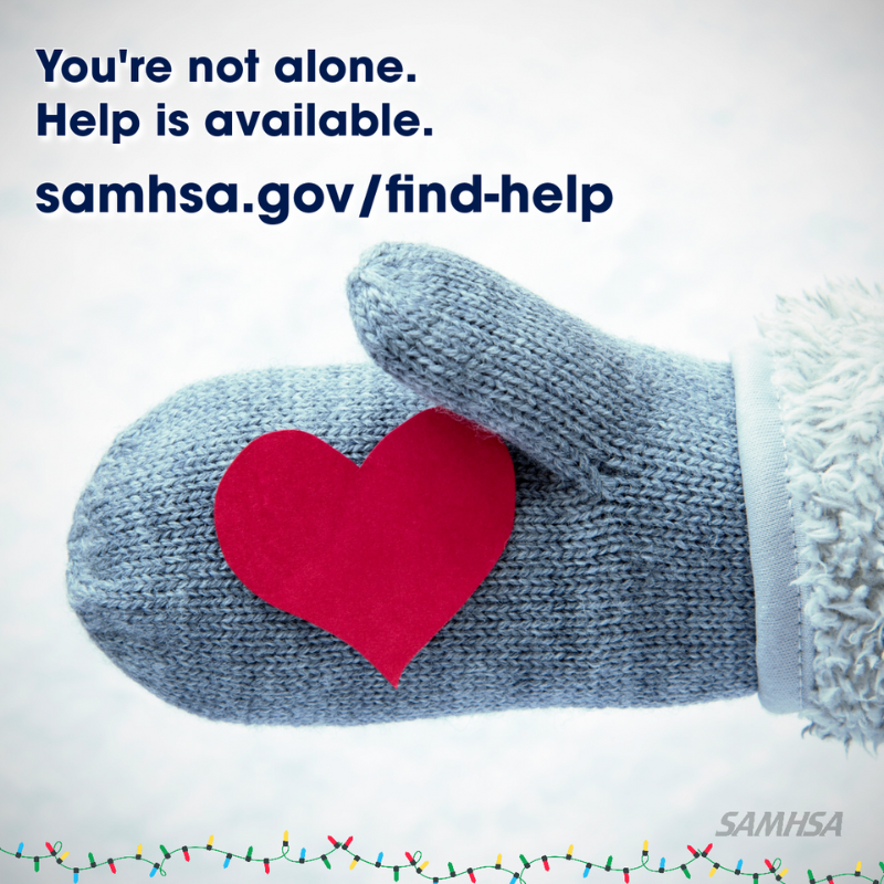 Warm blue knitted mitten holding a red heart in snow. You’re not alone. Help is available. samhsa.gov/find-help