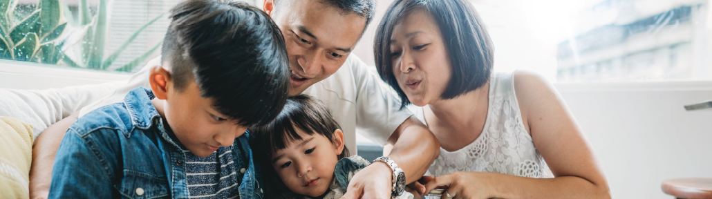 family looking at phone together