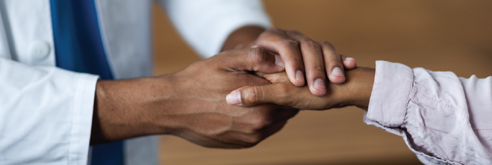 doctor holding patients hand