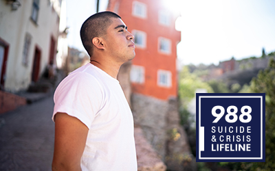 Latino man standing on sidewalk