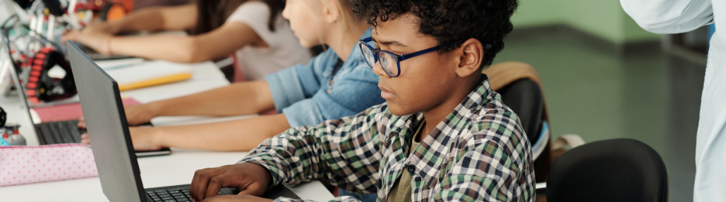 kid typing on computer banner