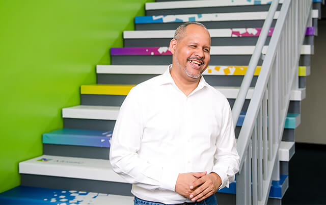 Man in front of colorful stairs