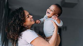 mother holding her baby in the air