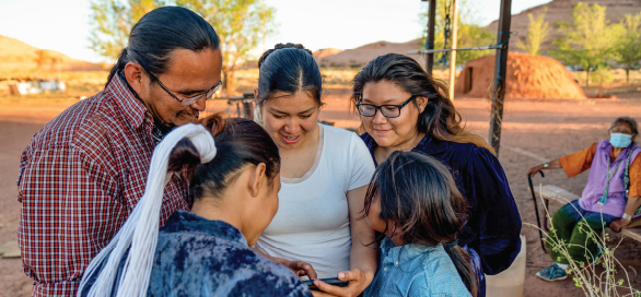 Indigenous family gathered in a circle