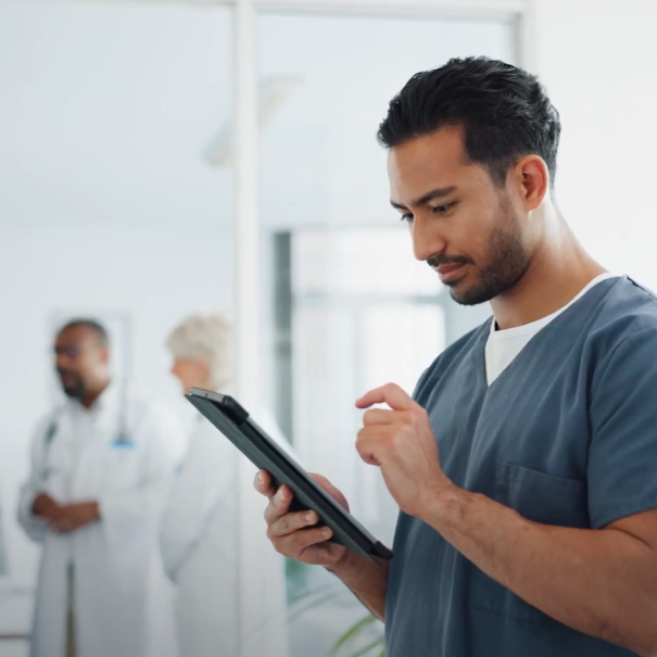 A photo of a healthcare employee working on a laptop. 