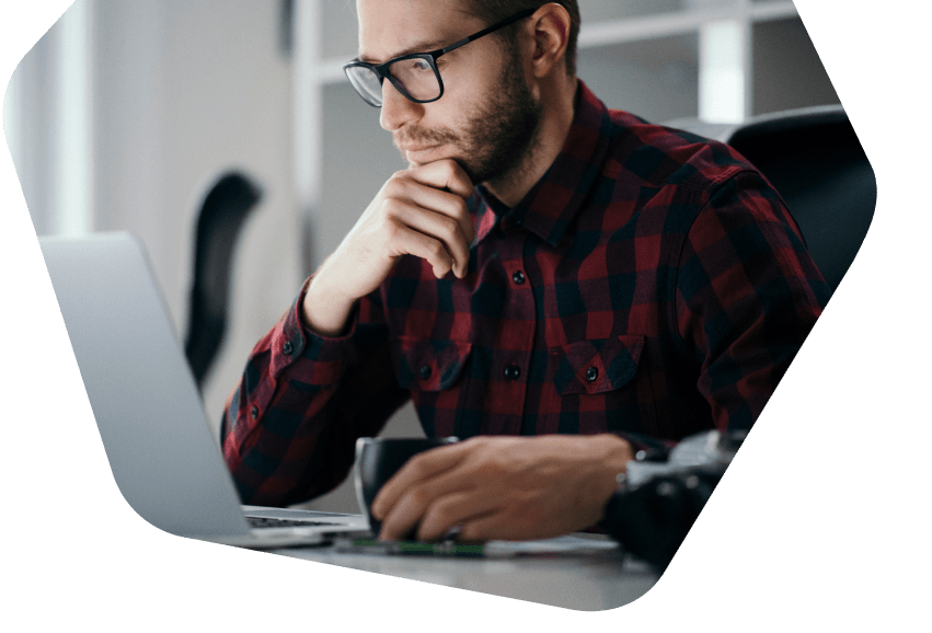 Man at home working using his phone and laptop