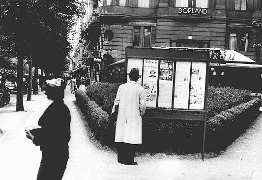 A pedestrian stops to read an issue of the antisemitic newspaper "Der Stuermer" (The Attacker) in a Berlin display box.