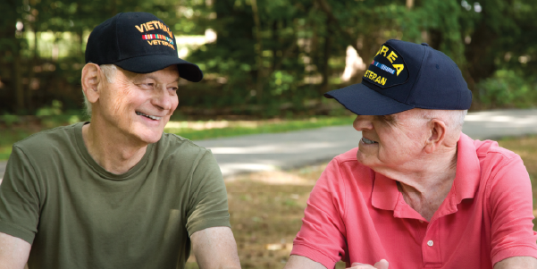 two veterans sitting down looking at each other.