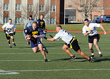 Photograph of men playing flag football