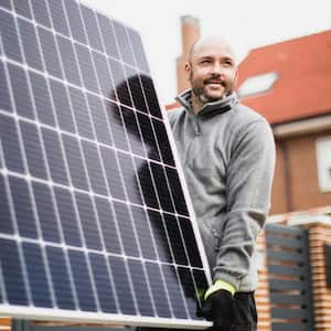 Construction worker installing solar panels