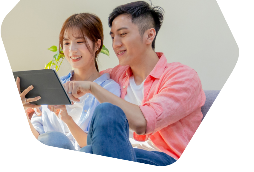 Young couple using their tablets at home