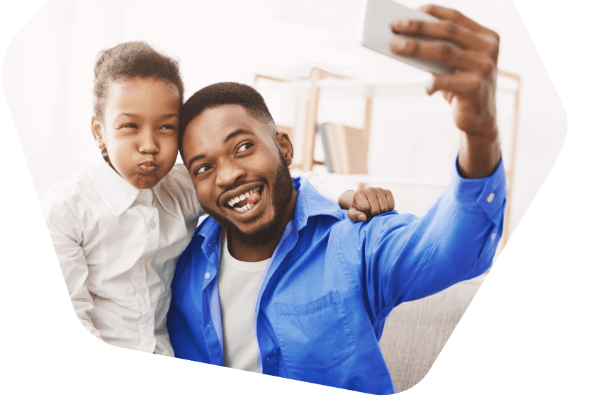 Father and son taking a selfie on mobile phone