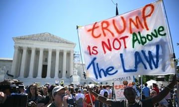 People protest before the US supreme court building, with one bearing a sign reading TRUMP IS NOT ABOVE THE LAW.