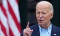 Biden gestures in front of a US flag.