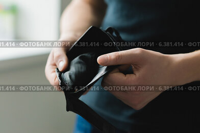 Man holding an empty wallet