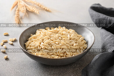 Pasta Cavatelli in bowl on gray background.