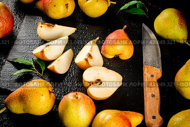 Sliced ripe pear with a knife.