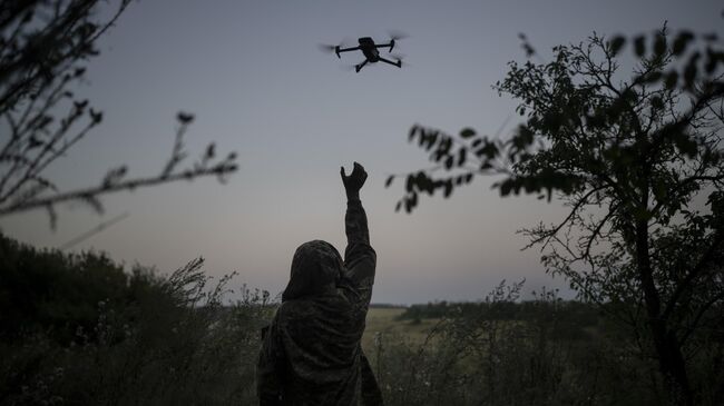 Украинский военный запускает беспилотник